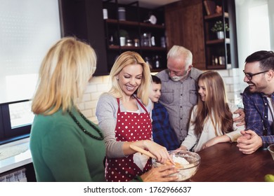 Multi Generation Family Cooking Meal At Home