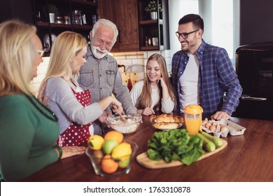 Multi Generation Family Cooking Meal At Home