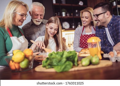 Multi Generation Family Cooking Meal At Home