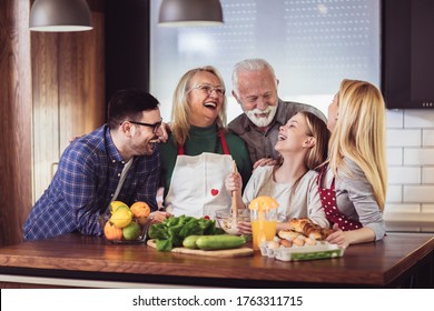 Multi Generation Family Cooking Meal At Home