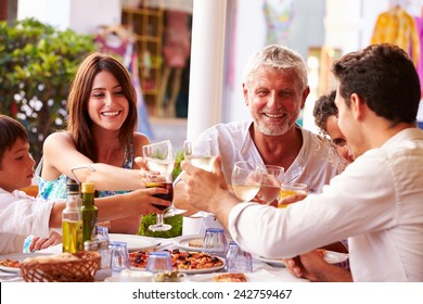 Multi Generation Family Eating Meal At Outdoor Restaurant