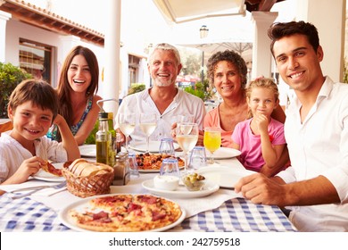 Multi Generation Family Eating Meal At Outdoor Restaurant