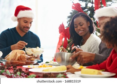 Multi Generation Family Enjoying Christmas Meal At Home