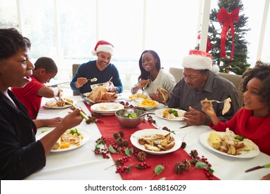 Multi Generation Family Enjoying Christmas Meal At Home