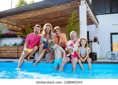 Multi generation family enjoying drinks when sitting at backyard pool. - Powered by Shutterstock