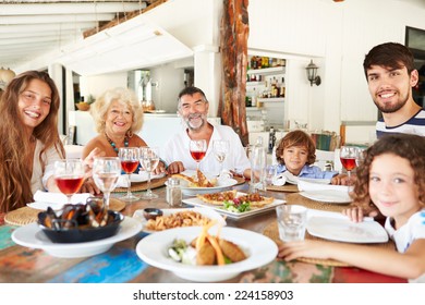 Multi Generation Family Enjoying Meal In Restaurant