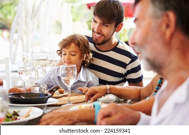 Multi Generation Family Enjoying Meal In Restaurant