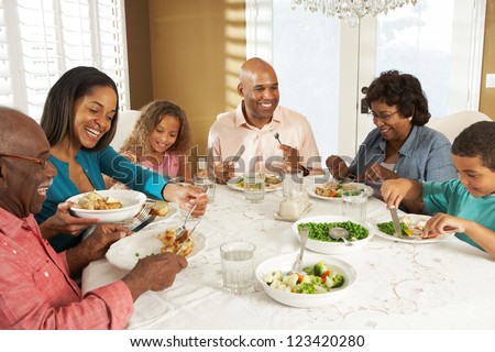 Multi Generation Family Enjoying Meal At Home