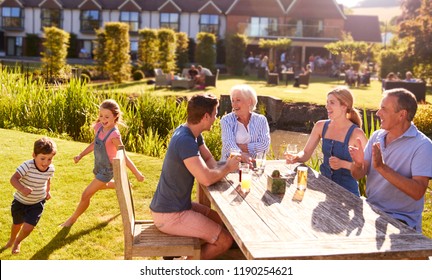 Multi Generation Family Enjoying Outdoor Summer Drink At Pub