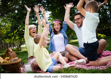 Multi Generation Family Enjoying Picnic In A Park