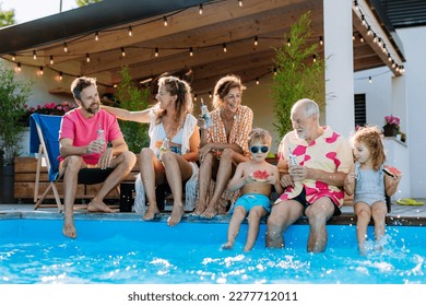 Multi generation family enjoying summer time, sitting at backyard pool. - Powered by Shutterstock