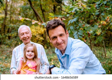 Multi generation family enjoying time together in nature.Grandfather,child girl and father outdoors in woods - Powered by Shutterstock