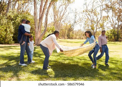 Multi Generation Family Going On Picnic In Park Together - Powered by Shutterstock