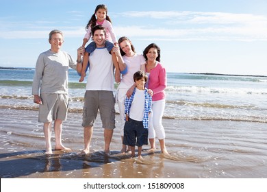 Multi Generation Family Having Fun On Beach Holiday