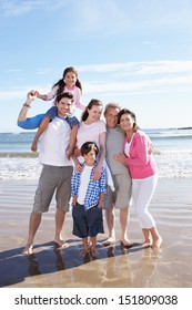 Multi Generation Family Having Fun On Beach Holiday