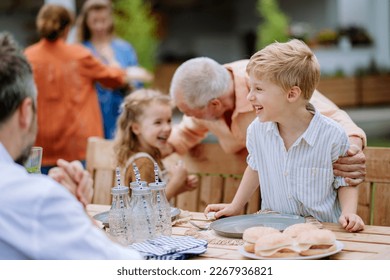 Multi generation family having outdoor garden party. - Powered by Shutterstock