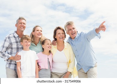 Multi Generation Family Looking Away At The Beach