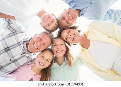 Multi Generation Family Looking Down At The Beach