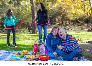 A multi generation family at the picnic with hula hoop , picnic concept with family and grandparents  - Powered by Shutterstock