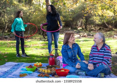 A multi generation family at the picnic with hula hoop , picnic concept with family and grandparents  - Powered by Shutterstock