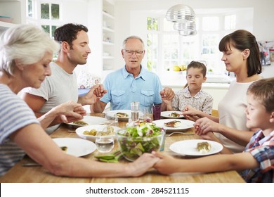 Multi Generation Family Praying Before Meal At Home - Powered by Shutterstock