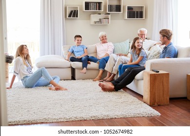 Multi Generation Family Relaxing On Sofa At Home Together