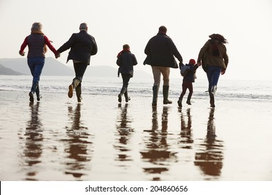 Multi Generation Family Walking On Winter Beach