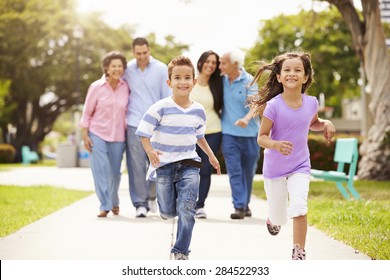 Multi Generation Family Walking In Park Together