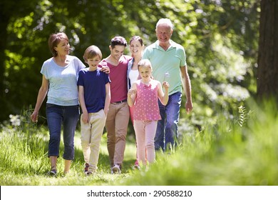 Multi Generation Family Walking Through Summer Countryside