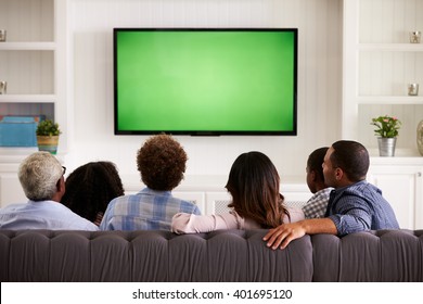 Multi generation family watching TV at home, back view - Shutterstock ID 401695120