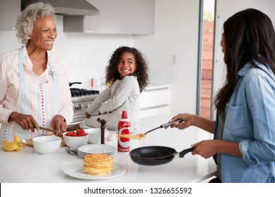 Multi Generation Female Family In Kitchen At Home Making Pancakes Together - Powered by Shutterstock