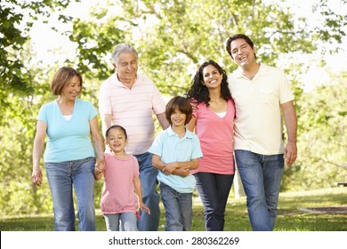 Multi Generation Hispanic Family Walking In Park