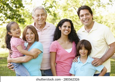 Multi Generation Hispanic Family Walking In Park