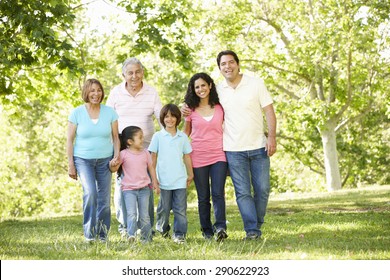 Multi Generation Hispanic Family Walking In Park