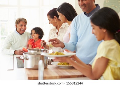 Multi Generation Indian Family Cooking Meal At Home