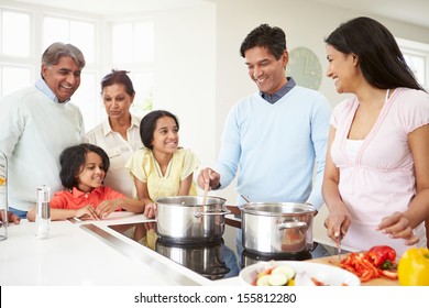 Multi Generation Indian Family Cooking Meal At Home