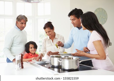 Multi Generation Indian Family Cooking Meal At Home