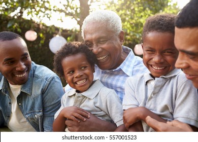 Multi Generation Male Family Members Gathered In A Garden