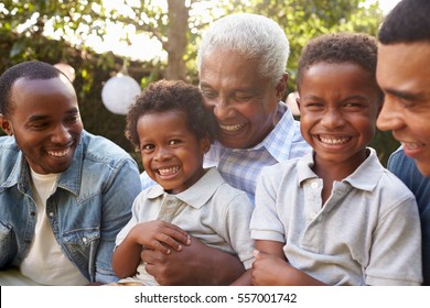 Multi Generation Male Family Members Gathered In A Garden