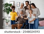 Multi generation, multiethnic family at home together, grandfather with disability