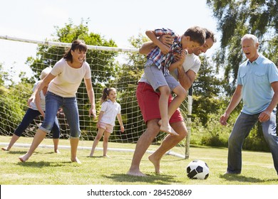 Multi Generation Playing Football In Garden Together - Powered by Shutterstock