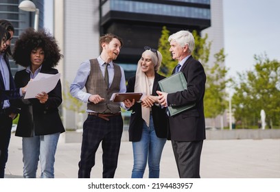 Multi Generational Business People Working Outside Of Office Building