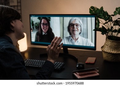 Multi Generational Business Women Having Video Call With Her Colleagues Using Computer App - Soft Focus On Right Hand