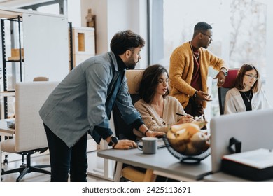 Multi generational, diverse coworkers collaborate, analyze statistics, exchange ideas, and plan for company growth in a creative office. - Powered by Shutterstock