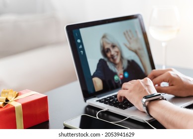 Multi Generational Family Celebrating Christmas On Video Call - Senior Woman Chat And Meeting On Laptop Computer - Focus On Left Hand