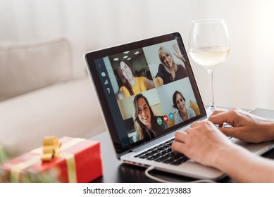 Multi Generational Family On Video Call Celebrating Christmas Online On Group Conference Meeting With Wine Using Computer Laptop - Focus On Screen