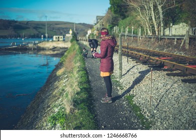 A Multi Generational Family With A Toddler And Grandfather Are Walking By The Railway Tracks