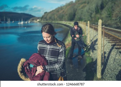 A Multi Generational Family With A Toddler And Grandfather Are Walking By The Railway Tracks