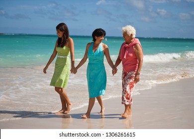 Multi Generational Family Walking On Beach