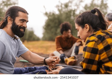 Multi generational farm workers collecting olives in their hands during the olive harvest season, showcasing teamwork and the agricultural process - Powered by Shutterstock